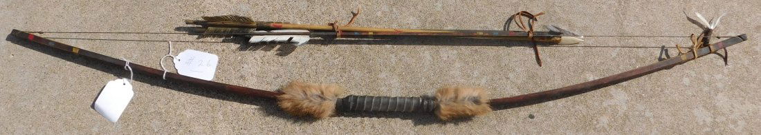 Plains Bow and 3 Arrows: Plains Bow and 3 Arrows, item is mid-20th Century. This lot is made from wood, leather, fur, bone and steel. The bow is 47 x 1 x 1 and the arrows are 25" long. One arrow has bone point. Condition: The