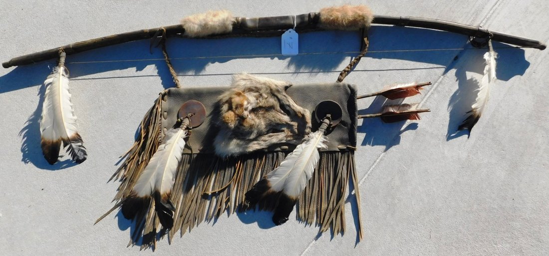 Plains Indian Bow, Arrows and Quiver: Plains Indian Bow, Arrows and Quiver, circa 1900s. The bow measures 54" x 2" x 2" and the quiver is 18" x 7" x 2". This item features rawhide, wood, feathers, fur, brass tacks and glass beads. Please 