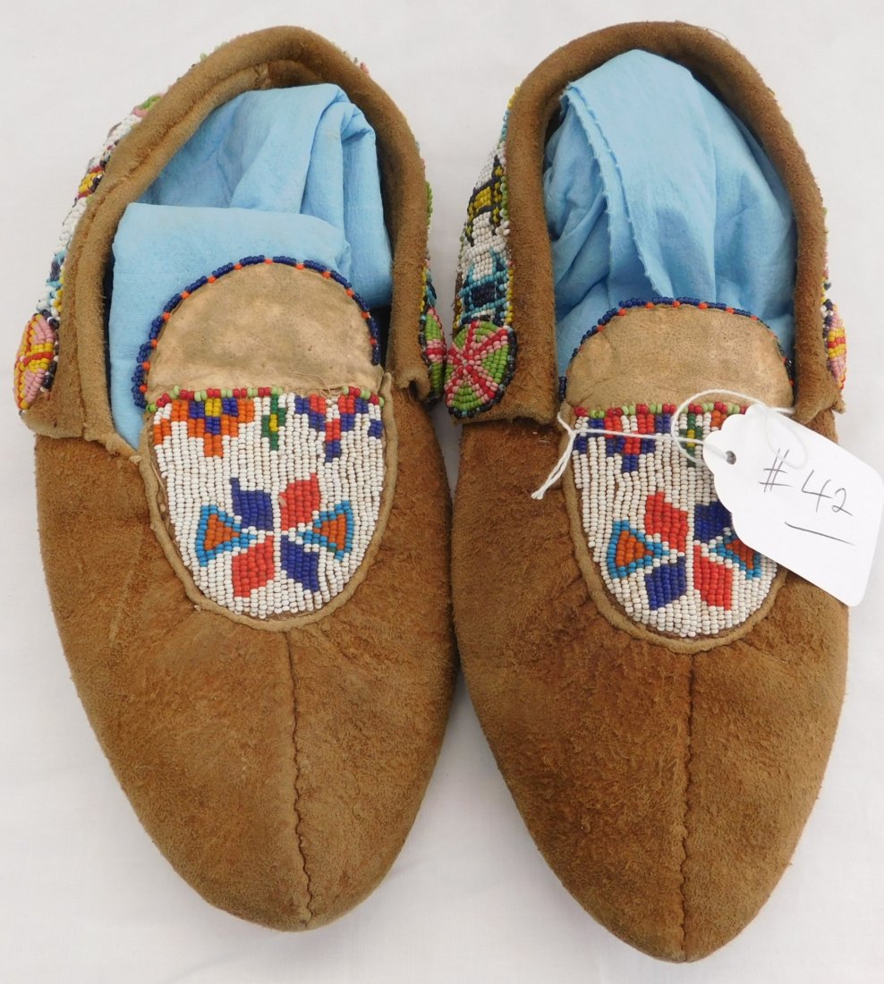 Old Moose Hide Moccasins: Old Moose Hide Moccasins, circa 1920s. Believed to be from the Cree Tribe in Central Canada. These moccasins measure 10 1/2 x 4 inches. Condition: They are well worn with a hole or two in the sole, se