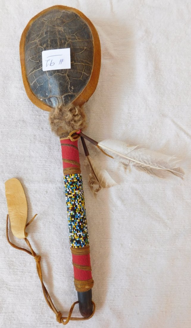 Beaded Turtle Rattle: Beaded Turtle Rattle, circa 1960s. Made of wood, glass beads and turtle shell, this rattle measures 16" x 5" x 3". From South Dakota. Nice sound, well made rattle. Condition: Very good, see images. Sh