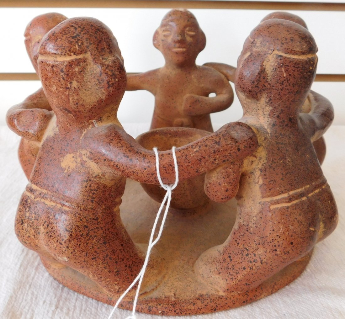 Mexican Circle of Friends Pottery: Mexican Circle of Friend Pottery, circa 1980s. Made of clay and measuring 8" x 5". From Central Mexico. 5 people around a clay pot. Condition: Minor scratches, see images. Shipping: $30.00, requires d