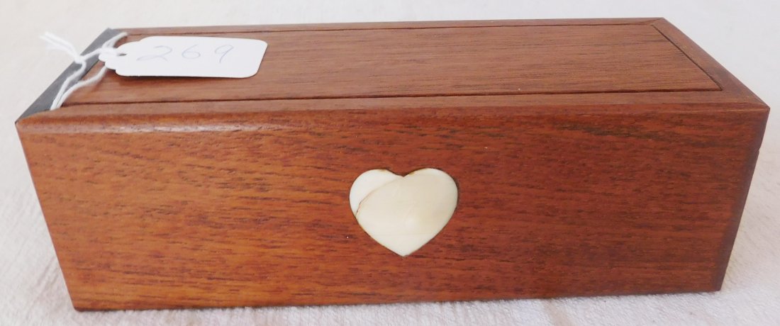 Inlaid Box w/Scrimshaw Dominoes: Inlaid Box w/Scrimshaw Dominoes, circa 1880s. Made of teakwood and bone, the item measures 7" x 2.75" x 2.25". Alaska. 25 black/white dominoes. 4 inlaid heart shapes, possibly a wedding gift. Conditio