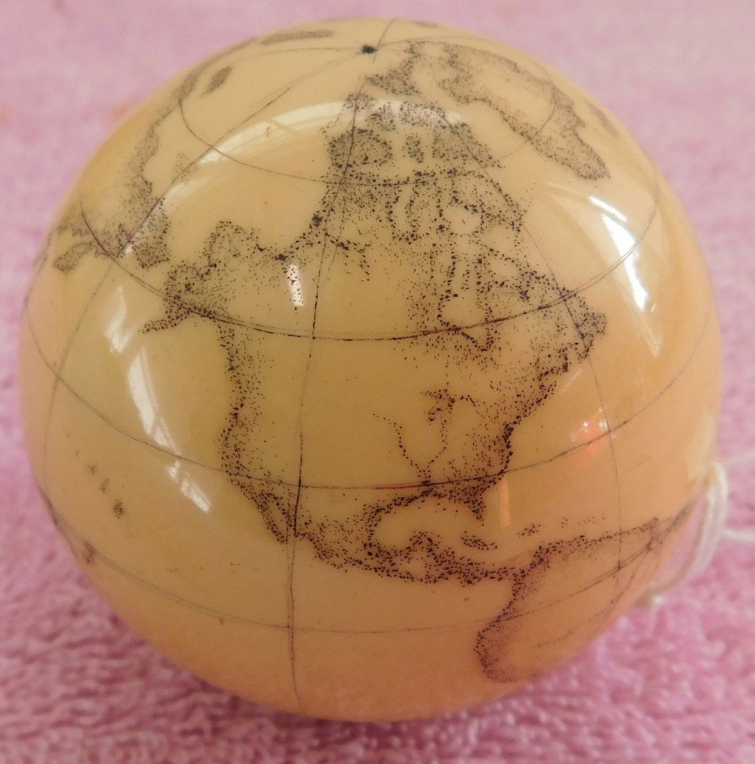Scrimshaw Cue Ball: Scrimshaw Cue Ball, circa 1990s. Item measures 2.25" around. USA. World map etched on ball. Condition: Good, see images. Shipping: $18.50 w/insurance and signature.