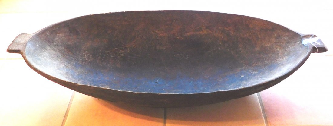 Large Polynesian Wood Bowl w/Helm COA: Large Polynesian Wood Bowl, circa WWII. Made of hardwood, the item measures 39" long x 15" x 7.5" tall. New Britain. Bowl was collected in WWII era, it may have been old then. Carved spout on one end 
