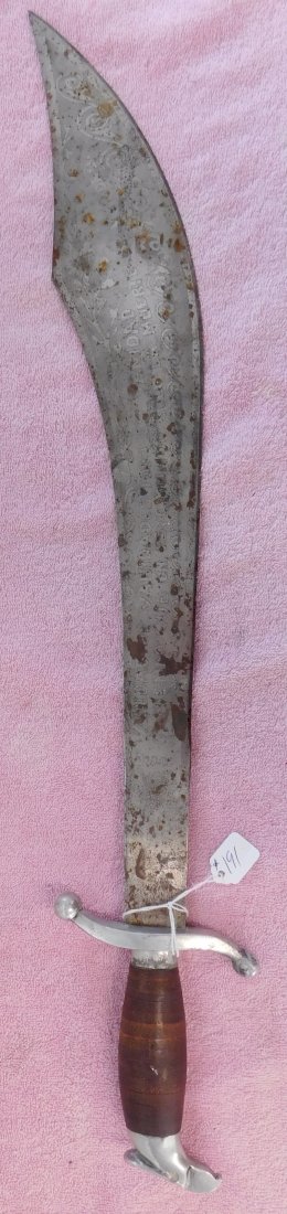 Older Mexican Sword w/Lettering: Older Mexican Sword w/Lettering, circa 1950s. Made of leather ring handle and steel, the item is 27" x 6". Mexico. Biblical message on blade in Spanish, "vanity of vanities, all is vanity, knowing in 