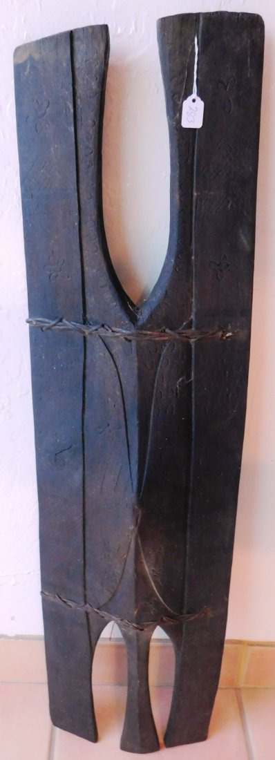 Early Wood War Shield w/COA: Early Wood War Shield, possibly 19th Century. Made of hardwood and vine sewn, the item is 10" x 37.5" x 3". Philippines. Engraving on face of shield. Ex. Maslyn Williams, author of Stone Age Island. H
