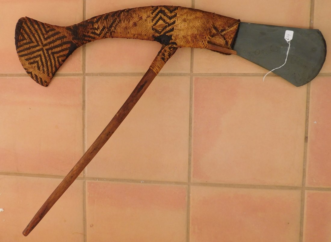 PNG Hafted Ceremonial Axe w/Helm COA: Papua New Guinea Hafted Ceremonial Axe w/Helm COA, circa WWII. Made of jadeite, ratan and wood, the item measures 33" x 24" x 2.5". PNG. Sharp jadeite blade. Ex. Masyln Williams, author of Stone Age I