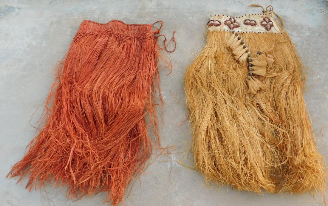 2 Polynesian Grass Skirts w/Helm COA: 2 Polynesian Grass Skirts, circa WWII. Made of grass and fiber with seedpods, the items as photographed are 13" x 33" and 15" x 31", Tonga. One has fancy weaving and the other has fancy seedpod decora