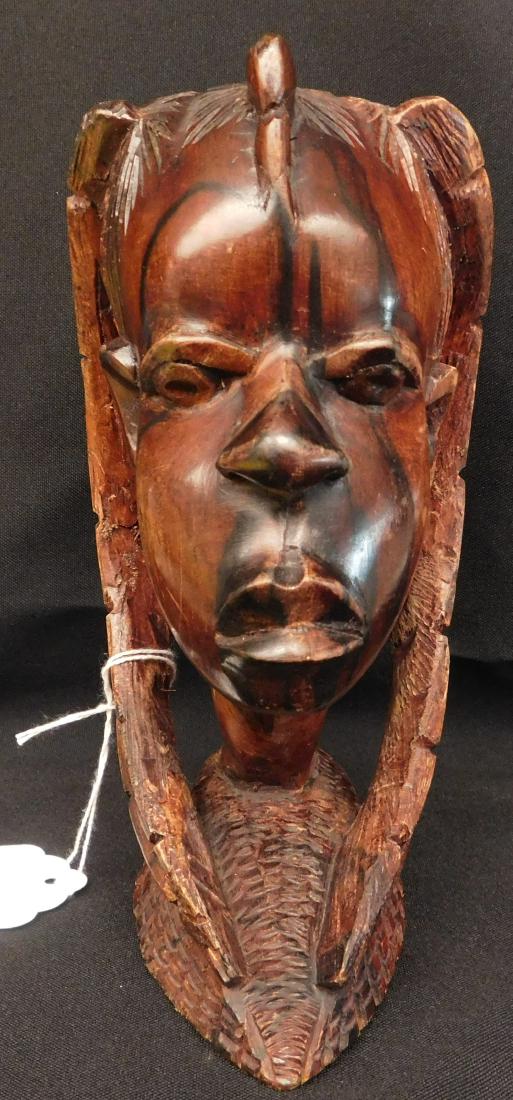 African Female Wood Carving: African Female Wood Carving, circa 1950s. Made of hardwood and measuring 7.75" tall x 4" x 5". Central Africa. Female's head wood carving, intricately carved all over. Great facial features and polish