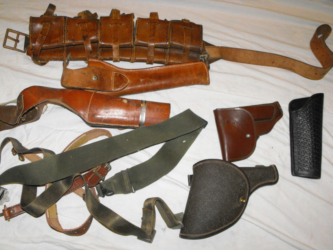 Ammo Belt & Gun Holsters: Collection of gun holsters, ammo belt from WWII or WWI, and accessories