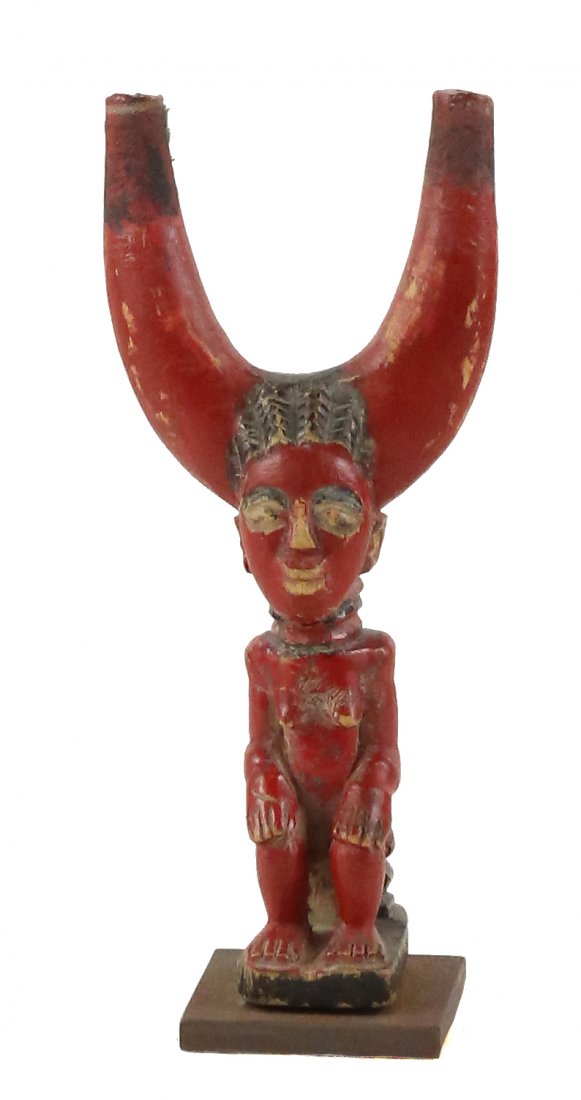 STYLE OF ZAMBLE SOCIETY TRANSITIONAL SLINGSHOT: Property of Lynn University to benefit the Library Renovation Fund To be sold subject to no reserve STYLE OF Zamble Society Transitional Slingshot- carved wood painted red of seated female ancestral f