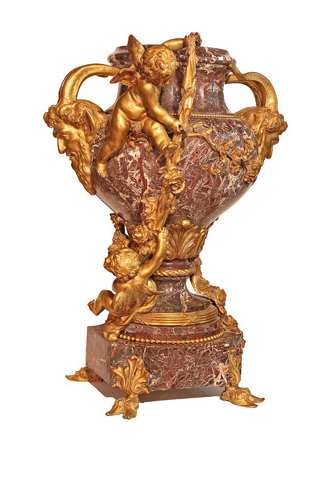 A French ormolu and marble jardiniere In the manner: A French ormolu and marble jardiniere In the manner of Robert Feres, Late 19th century The baluster urn flanked by a pair of satyr mask handles and two winged putti suspending floral garlands, on a sp