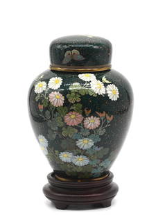 Japanese Cloisonne Enamel Covered Jar: Japanese Cloisonne Enamel Covered Jar The ovoid vessel with a second inside metal lid, the whole decorated with colorful flowers and butterflies on a gilt speckled green ground. Height 5.75 in., Diame