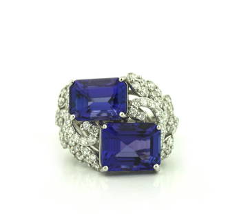 Platinum Diamond and Tanzanite Ring: Platinum Diamond and Tanzanite RingFeaturing Two Bluish Violet Natural Tanzanite Emeralds With Intense Color and Type 1 Clarity Vertically paired, weighing 10.67 carats measuring 11.34 x 9.15 mm and 1