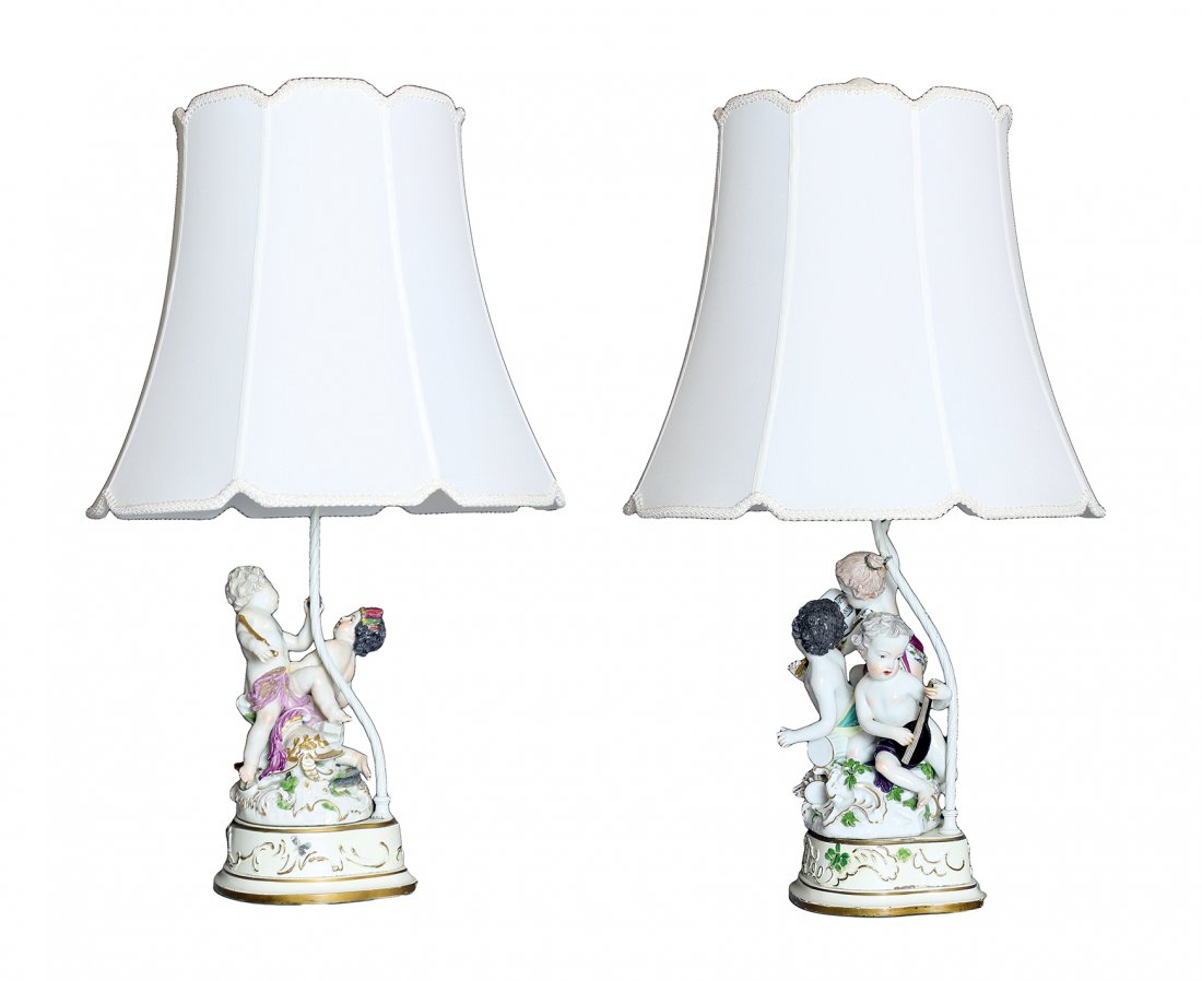 PAIR OF CONTINENTAL PORCELAIN FIGURAL TABLE LAMPS: PROPERTY FROM A BOCA RATON ESTATE: A PAIR OF CONTINENTAL PORCELAIN FIGURAL TABLE LAMPS With porcelain putti figurines in various pursuits, on plinths on composition wood bases, and each with two light