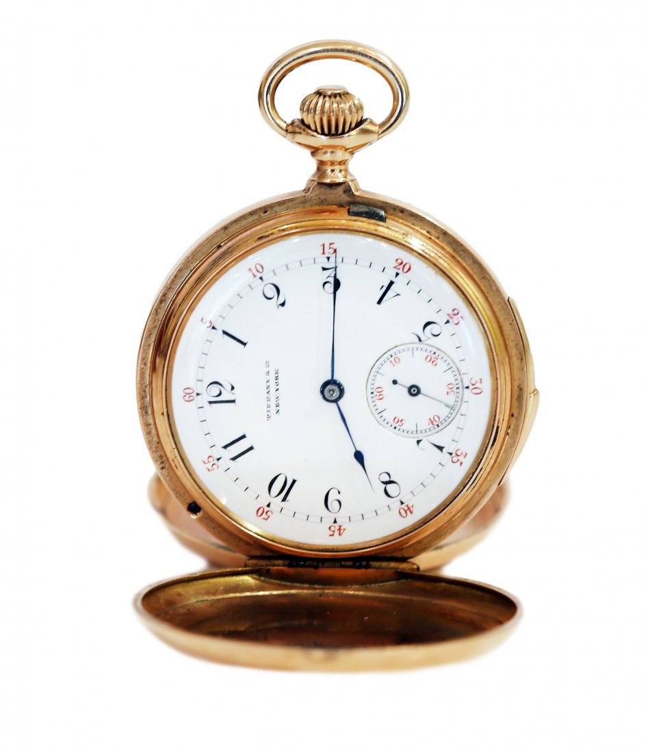 EIGHTEEN KARAT GOLD POCKET WATCH, BY TIFFANY & CO.: AN EIGHTEEN KARAT YELLOW GOLD POCKET WATCH, BY TIFFANY & CO. A gold pocket watch with Tiffany signed movement, with a white enamel dial and a second hand sub dial, with hunter’s case in gold, having