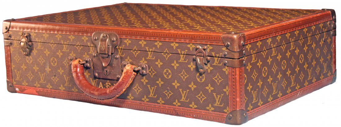 LOUIS VUITTON VINTAGE HARD SIDED SUITCASE: This richly stylish Louis Vuitton Vintage Medium Size Hard Sided Suitcase is covered with a traditional monogramed canvas, with leather handle and reinforced brass corners; the hardware appears to ret