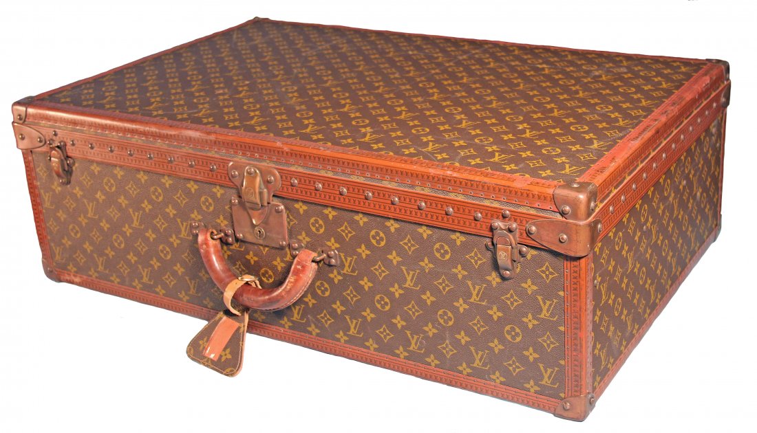 LOUIS VUITTON VINTAGE HARD SIDED SUITCASE: This beautifully handcrafted vintage Large Louis Vuitton hard sided suitcase is covered in the traditional monogramed canvas, with a leather handle and reinforced brass corners with brass rivets engra