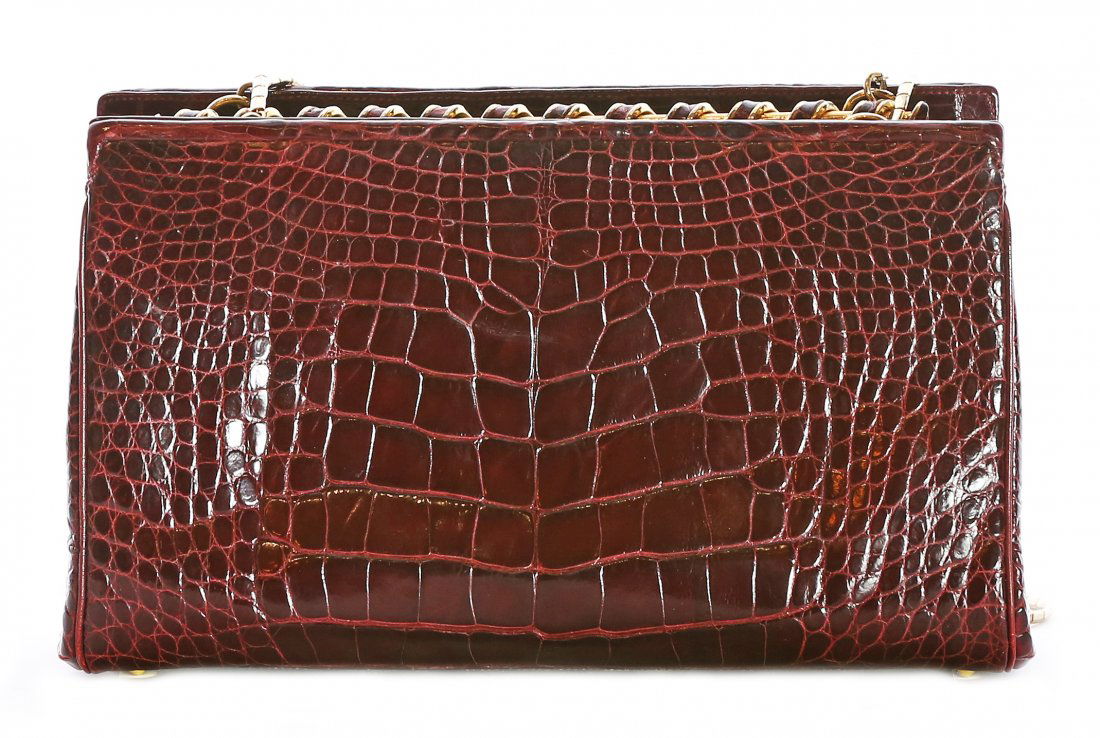 JUDITH LEIBER ALLIGATOR SHOULDER BAG: PROPERTY OF A PALM BEACH LADY: JUDITH LEIBER ALLIGATOR AND CHAIN LINK SHOULDER BAG Hardware signed Judith Leiber, with red satin lining. Length 7 1/2 Height 4 1/2 inches.