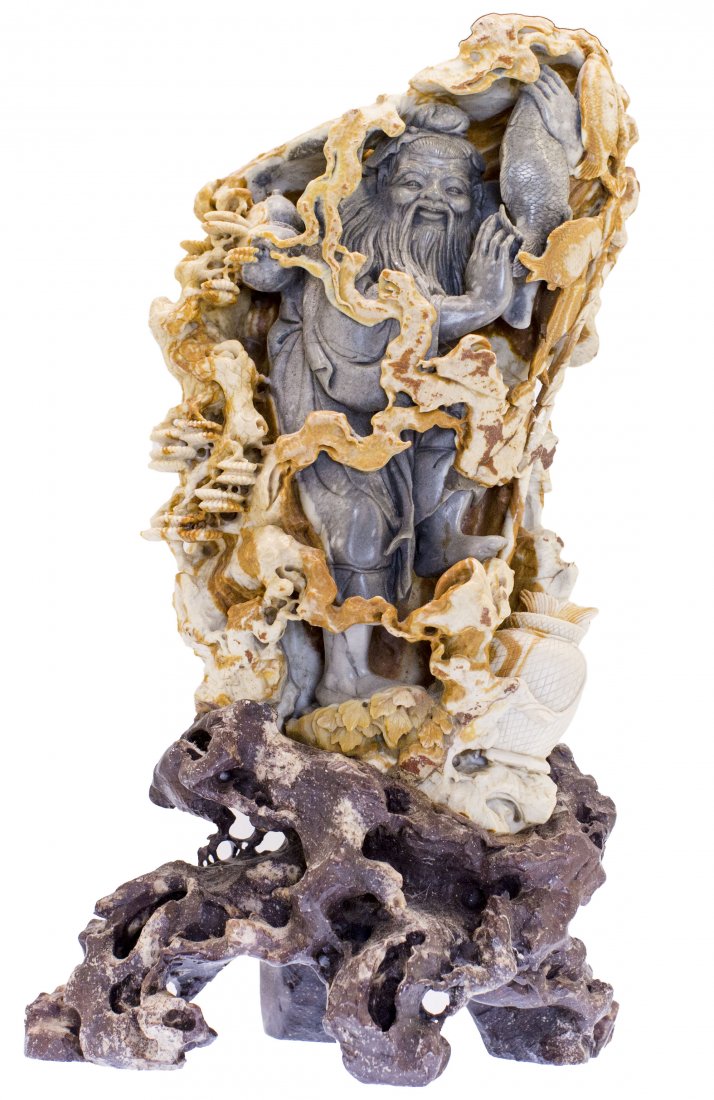 CHINESE CARVED SOAPSTONE FIGURE OF A FISHERMAN: PROPERTY OF A SAN FRANCISCO GENTLEMAN: CHINESE CARVED SOAPSTONE FIGURE OF A FISHERMAN Mounted on a carved stone rock form plinth base. Height 15 inches.