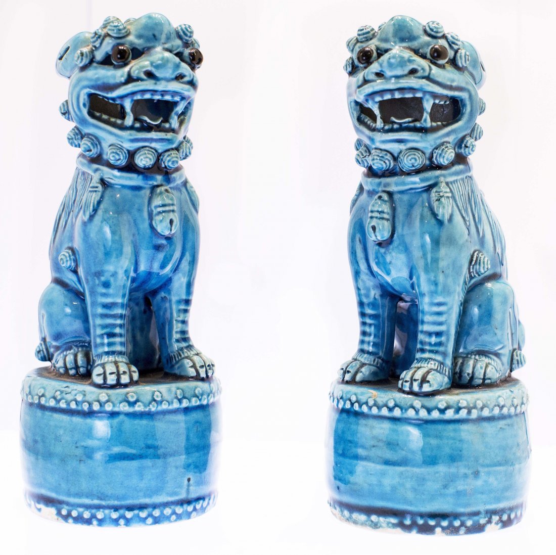 PAIR OF CHINESE TURQUOISE GLAZE PORCELAIN FOO DOGS: PAIR OF CHINESE TURQUOISE GLAZE PORCELAIN FOO DOGS Qing Dynasty, 19th Century. Each on a drum form base. Height 8 1/4 inches. Provenance: Doyle NY 2008