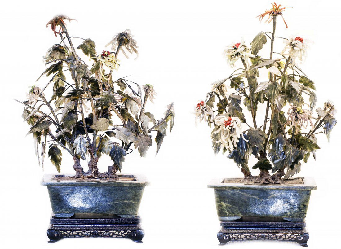 PAIR OF CHINESE CARVED JADE POTTED FLOWERS: PAIR OF CHINESE CARVED JADE POTTED FLOWERS In multiple colored stones, set in a rectangular carved green jade base. Height 20 inches.
