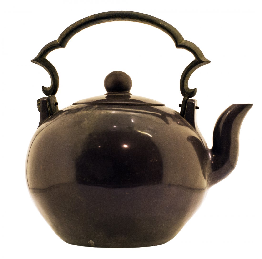CHINESE YIXING POTTERY TEAPOT AND COVER: PROPERTY OF A MIAMI-DADE COLLECTOR: CHINESE YIXING POTTERY TEAPOT AND COVER Qing Dynasty, 19th Century. Impressed marks on the underside. Highly polished pottery in purple brown patina with a metal ha