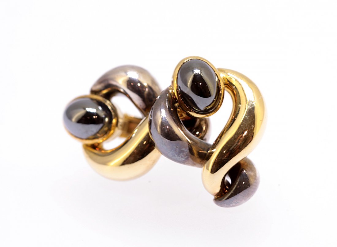 PAIR 18KT YELLOW GOLD, SILVER AND HEMATITE EARCLIP: 187. PAIR 18KT YELLOW GOLD, SILVER AND HEMATITE EARCLIPS by R. Boivin, signed R.BOIVIN and with French marks. Each designed with a yellow gold and a silver crossover s, centered by a cabochon hematite