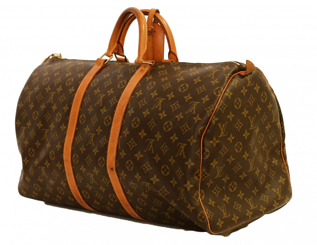LOUIS VUITTON CANVAS DUFFEL BAG: 273. LOUIS VUITTON CANVAS DUFFEL BAG Stamped Louis Vuitton Paris Made in France on keys and hardware. In original leather and mon monogram canvas, with leather handles, a center zipper with lock, key 