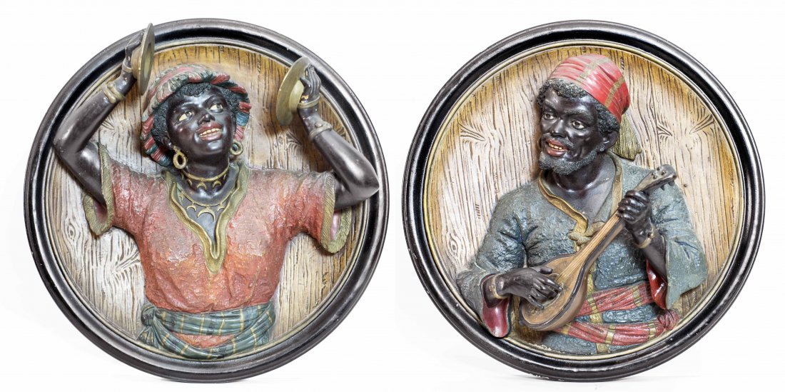 PAIR ITALIAN POTTERY BLACKMOOR PLAQUES: PAIR ITALIAN POTTERY BLACKMOOR PLAQUES Each of a musician playing an instrument. Diameter 16 1/4 inches.