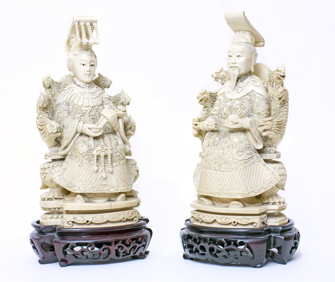 PAIR CHINESE CARVED IVORY EMPEROR AND EMPRESS: PAIR CHINESE CARVED IVORY FIGURE OF AN EMPEROR AND EMPRESS Each seated in elaborate thrones, one holding a scroll and the other a scepter. Height 9 1/2 inches. Together with carved wood fitted bases.