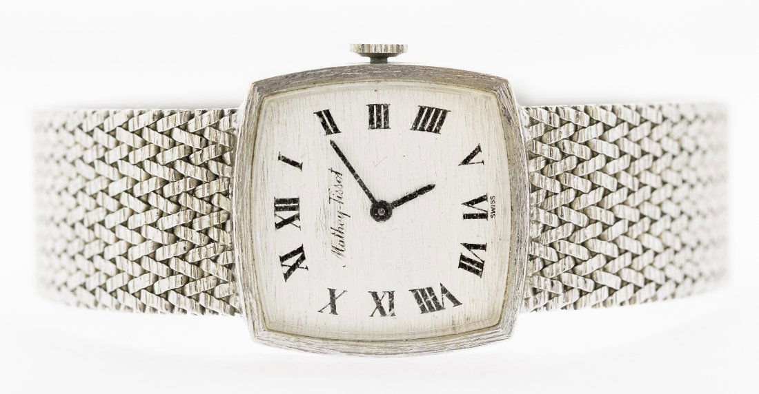 MATHEY-TISSOT 14KT WHITE GOLD GENTS WRISTWATCH: MATHEY-TISSOT 14KT WHITE GOLD GENTS WRISTWATCH The cushion shaped florentine dial, with printed Roman numeral indicators. On a 14kt white gold mesh bracelet with locking clasp. Length 8 inches, Weight