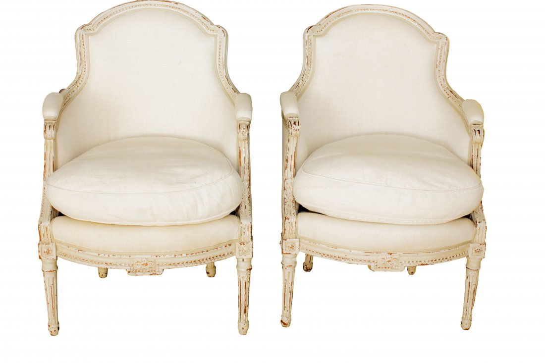 PAIR LOUIS XVI STYLE PAINTED BERGERES: PROPERTY OF A PALM BEACH GENTLEMAN: PAIR LOUIS XVI STYLE PAINTED BERGERES 20th Century. Each with upholstered backrest and padded arm rests, above loose seat cushion. Raised on fluted circular legs.