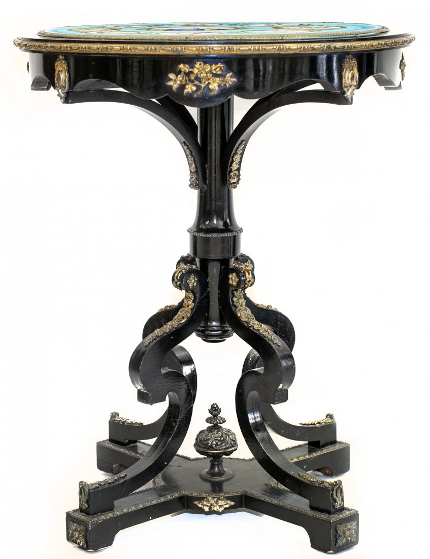 FRENCH SEVRES STYLE PORCELAIN AND EBONIZED TABLE: FRENCH NAPOLEON III GILT-BRONZE MOUNTED EBONIZED GUERIDON 19th Century. The circular top, inset with a Sevres Style porcelain plaque painted with the portrait of Henry IV, surrounded by eight oval pan