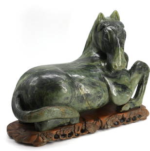 Chinese Spinach Jade Recumbent Horse: Chinese Spinach Jade Recumbent Horse The well-striated light to dark green jade with areas of pale gray and russet, on a prunus carved wood stand. Height of horse 10.25 in., Width 16 in., Depth