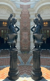 Pair of Large Patinated Bronze Figures of Boys atop Columns