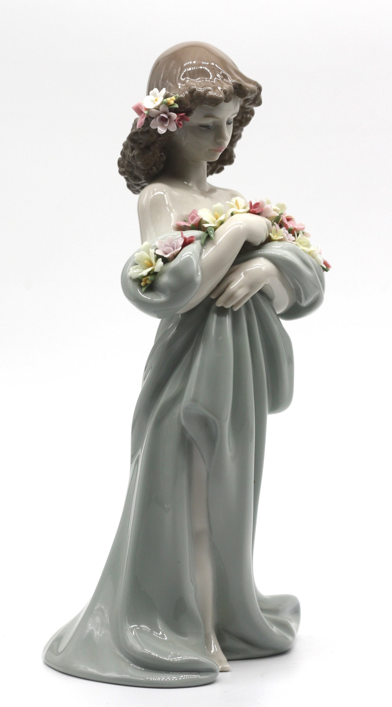 Lladro Porcelain Figure of a Young Girl Gathering Flowers: Lladro Porcelain Figure of a Young Girl Gathering Flowers Marked on the underside. Height 10 in., Width 4.75 in.
