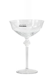 Lalique Coupe A Chamagne Roxane: Lalique Coupe A Chamagne Roxane Signed Lalique, France. The upper part of the stem frosted and molded with two putti, with its original box. . Height 6.75 in., Diameter 4.5 in.