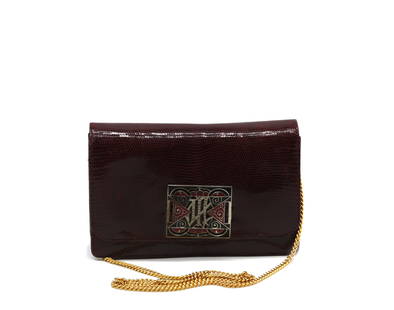 Eberle Brazilian Snake Skin and Enamel Clutch: Eberle Brazilian Snake Skin and Enamel Clutch The burgundy snake skin exterior, the flap with a art Deco Style silvered metal red and black enamel closure plate, with burgundy leather interior, gold