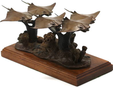 Contemporary Patinated Bronze Marine Sculpture: Contemporary Patinated Bronze Marine Sculpture Appears unsigned, depicting five stingrays swiming in formation above coral, chocolate brown patina, on a wood base. Overall, Height 7 in. Width 12.5
