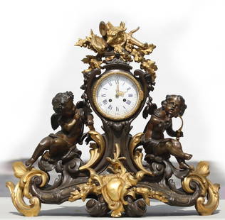 Large Louis XV Style Gilt and Patinated Bronze Mantel Clock: Large Louis XV Style Gilt and Patinated Bronze Mantel Clock Circa 1900, The overall body with bold scrolls, and acanthus leaves centering a gilt cartouche supporting two putti with arrors and a hunt