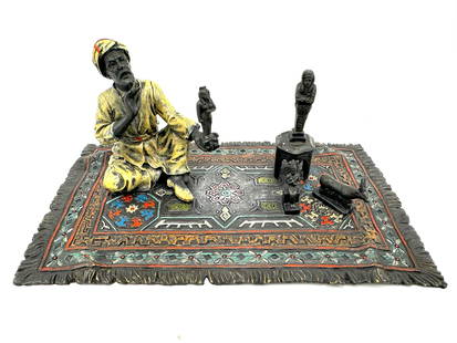 Franz Bergman, (Austrian, 1861-1936) Austrian Cold Painted Bronze: Franz Bergman, (Austrian, 1861-1936) Austrian Cold Painted Bronze the underside impressed Austria, with Bergman monogram. circa 1890, depicting an antiquities dealer seated on a rug, with Egyptian