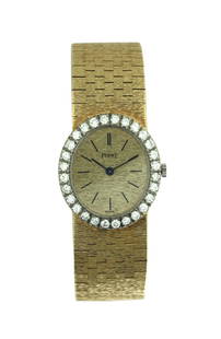 Piaget, A Yellow Gold and Diamond-set Bracelet Watch: Piaget A yellow gold and diamond-set bracelet watch, Circa 1980 Dial: champagne Caliber: cal. 9P mechanical, 18 jewels Case: 18k yellow gold and diamond-set, case back secured by two screws Case