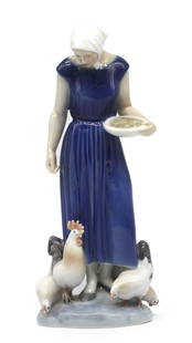 Royal Copenhagen Porcelain Figure of a Farm Maiden: Royal Copenhagen Porcelain Figure of a Farm Maiden Marked on the underside, numbered 584, in a blue dress with chickens by her feet. Height 9.5 in., Width 4 in.