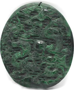 Fine Chinese Spinach Jade Oval Disc: Fine Chinese Spinach Jade Oval Disc Depicting a multitude of dragons amongst clouds, the reverse with a stylized design. Diameter 5 in. (12.7 cm.)
