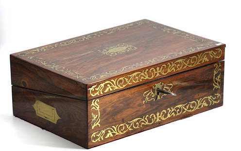Regency Brass Inlaid Rosewood Lap Desk: Regency Brass Inlaid Rosewood Lap Desk First half 19th Century. Fitted with two glass inkwells and a hinged velvet lined writing surface, the sides with campagne style handles. Height 4.75 in.,