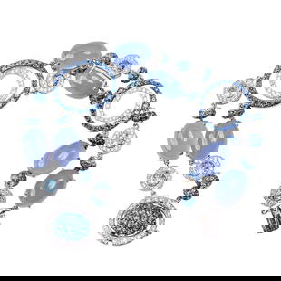 18 Karat White Gold, Chalcedony, and Diamond Bracelet: 18 Karat White Gold, Chalcedony, and Diamond Bracelet Of modern circular design, composed of alternating cabochon lavender-blue chalcedony panels, brilliant-cut diamond collets, and openwork circular