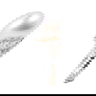 Platinum and 18 Karat White Gold South Sea Pearl and Diamond Ring: Platinum and 18 Karat White Gold South Sea Pearl and Diamond Ring Centering a magnificent South Sea pearl measuring approximately 15 mm, displaying exceptional luster and orient, flanked by two large