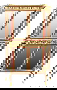 ÉMILE LÉGER & CIE, Gilt-Bronze Mounted Mahogany Vitrine: A Louis XVI Gilt-Bronze Mounted Mahogany Vitrine Cabinet Late 19th Century, the shaped rectangular top with a three-quarter gallery above a conforming divided case enclosing four glazed doors flanked