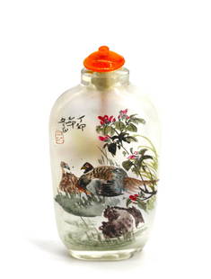 Chinese Reverse Painting on Glass Snuff Bottle: Chinese Reverse Painting on Glass Snuff Bottle The elongated ovoid bottle decorated with songbirds ans pheasants, each sided with signed verse, with an orange mineral cap and a spoon. Height 3.125